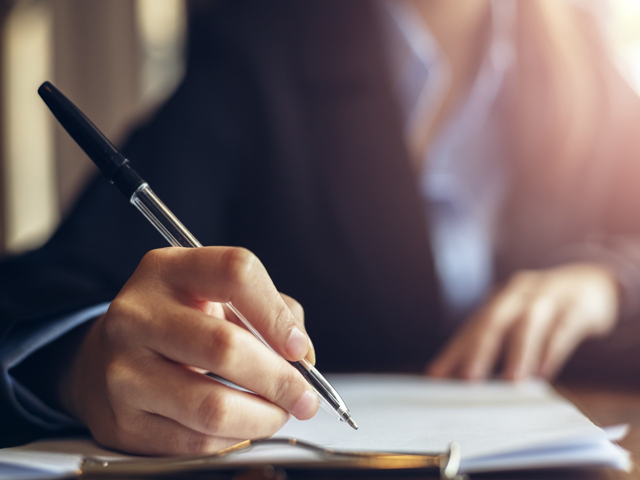 businesswomen calculating, writing and checking for making report financial.
