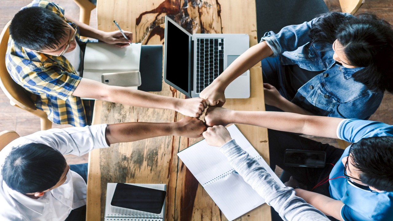 Group of teen high school students hands making fist bump gesture.student relationship concept